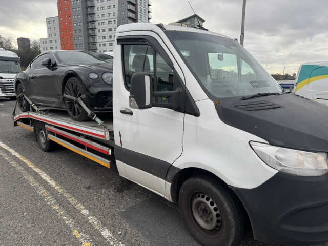 Flatbed tow truck recovering a car - Thamesmead