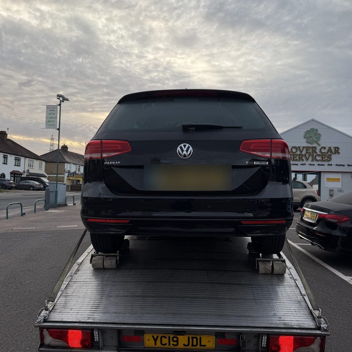 Rear view of a Recovery Car flatbed carrying a VW Passat, South East London