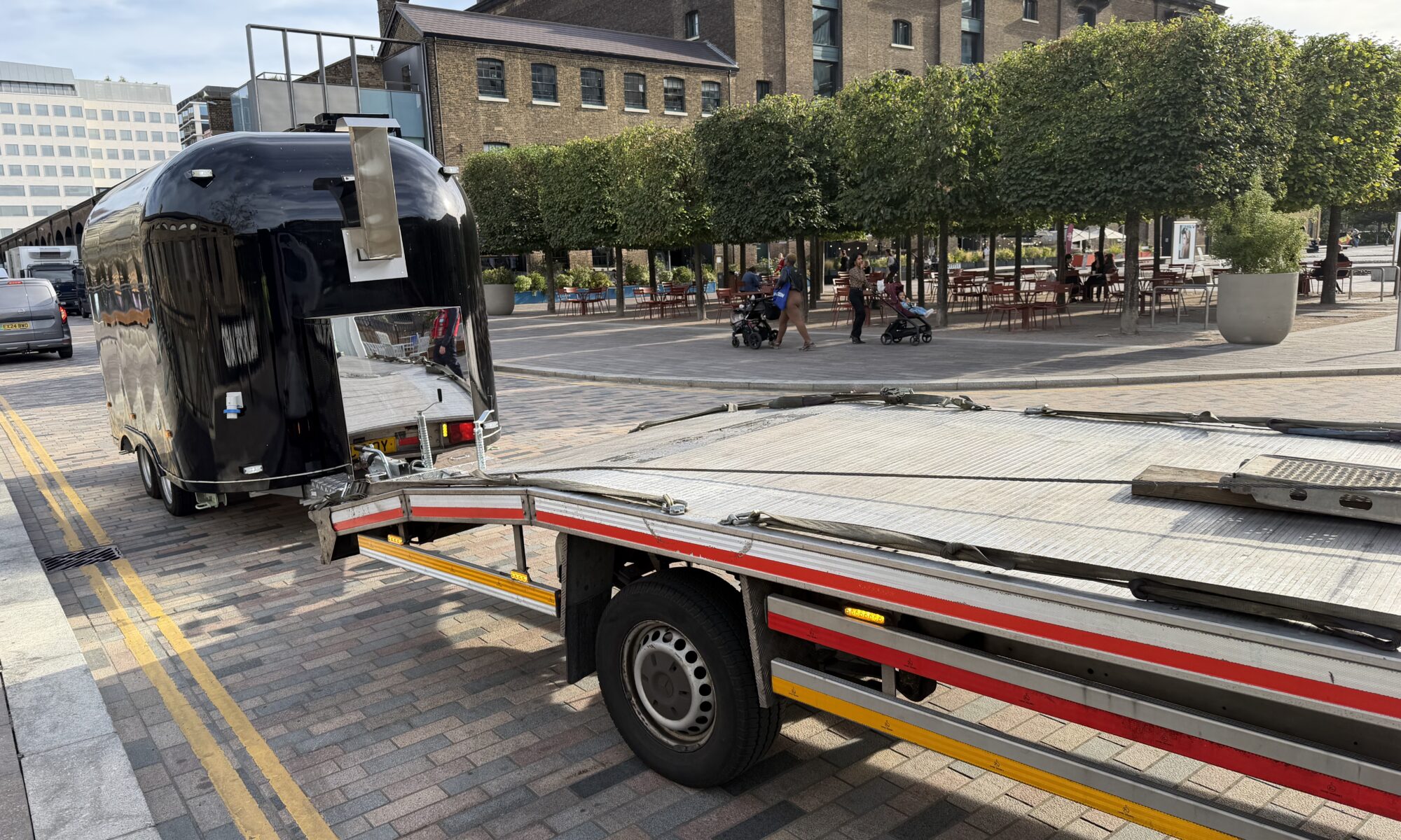 Towing a Caravan, Trailer or Boat? What to Do If Something Goes Wrong 1 Food trailer secured on RecoveryCar recovery truck ready for transport, King's Cross London