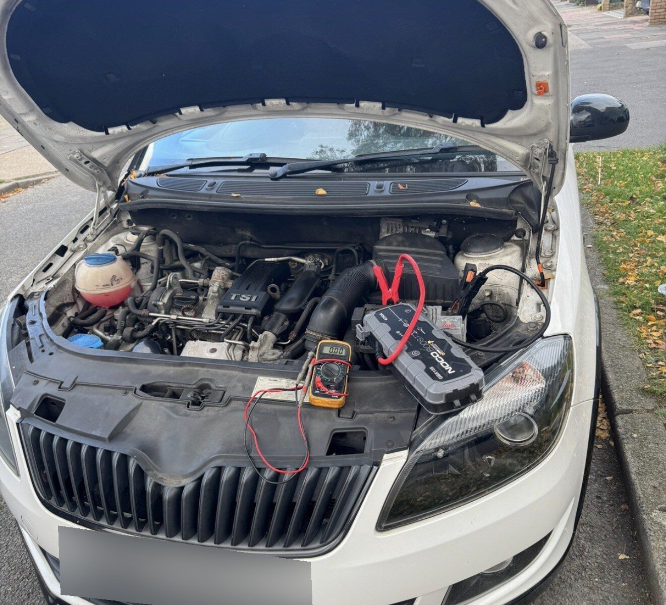 RecoveryCar technician jump starting a car with a NOCO booster in South East London