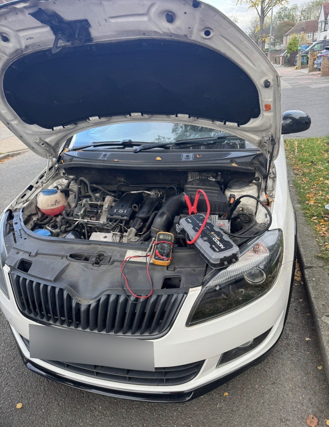 RecoveryCar technician jump starting a car with a NOCO booster in South East London
